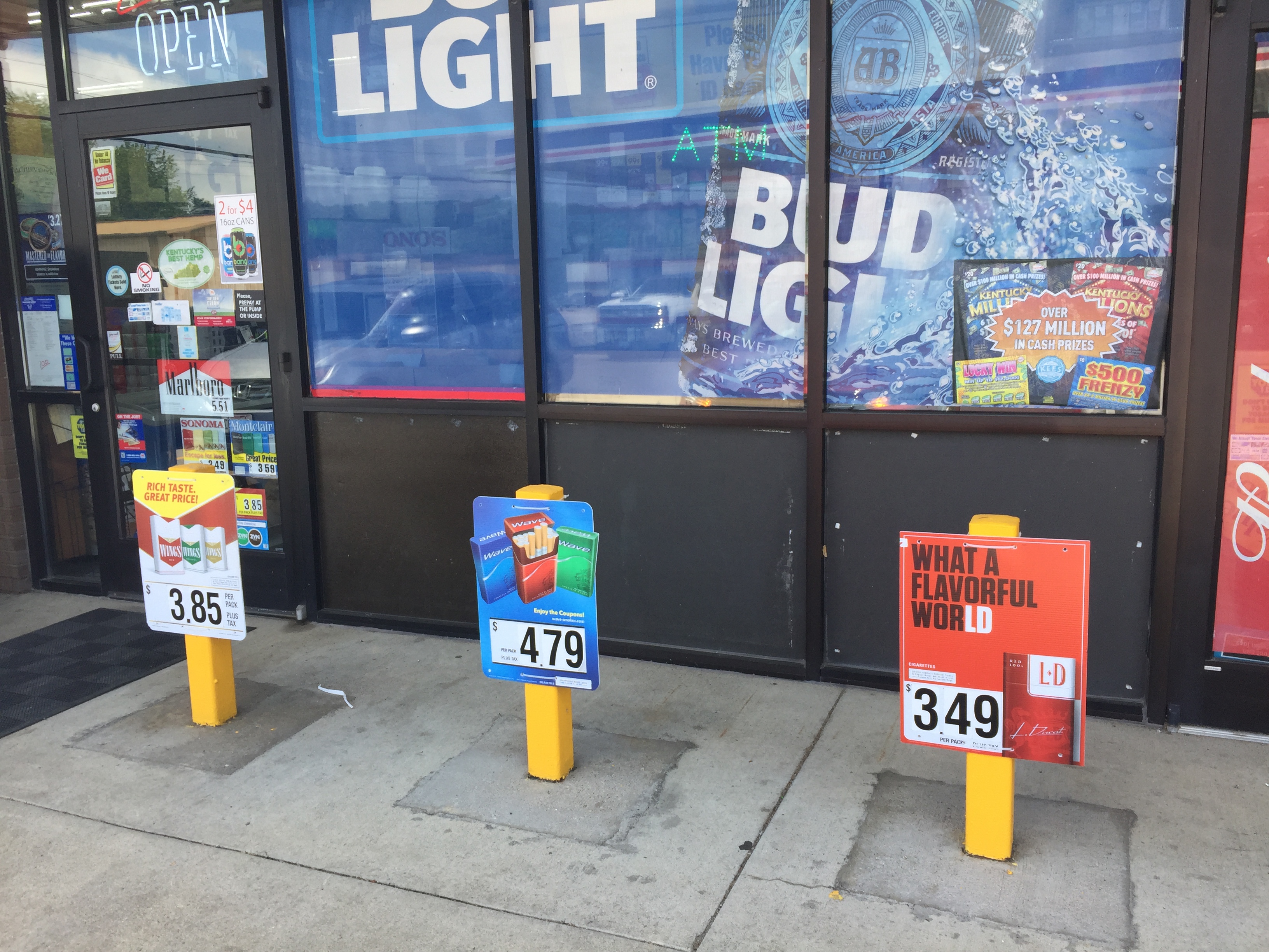 store exterior with Bud Light ads as well as cigarette ads 