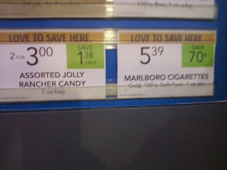 Tobacco being advertised directly beside candy at a gas station pump