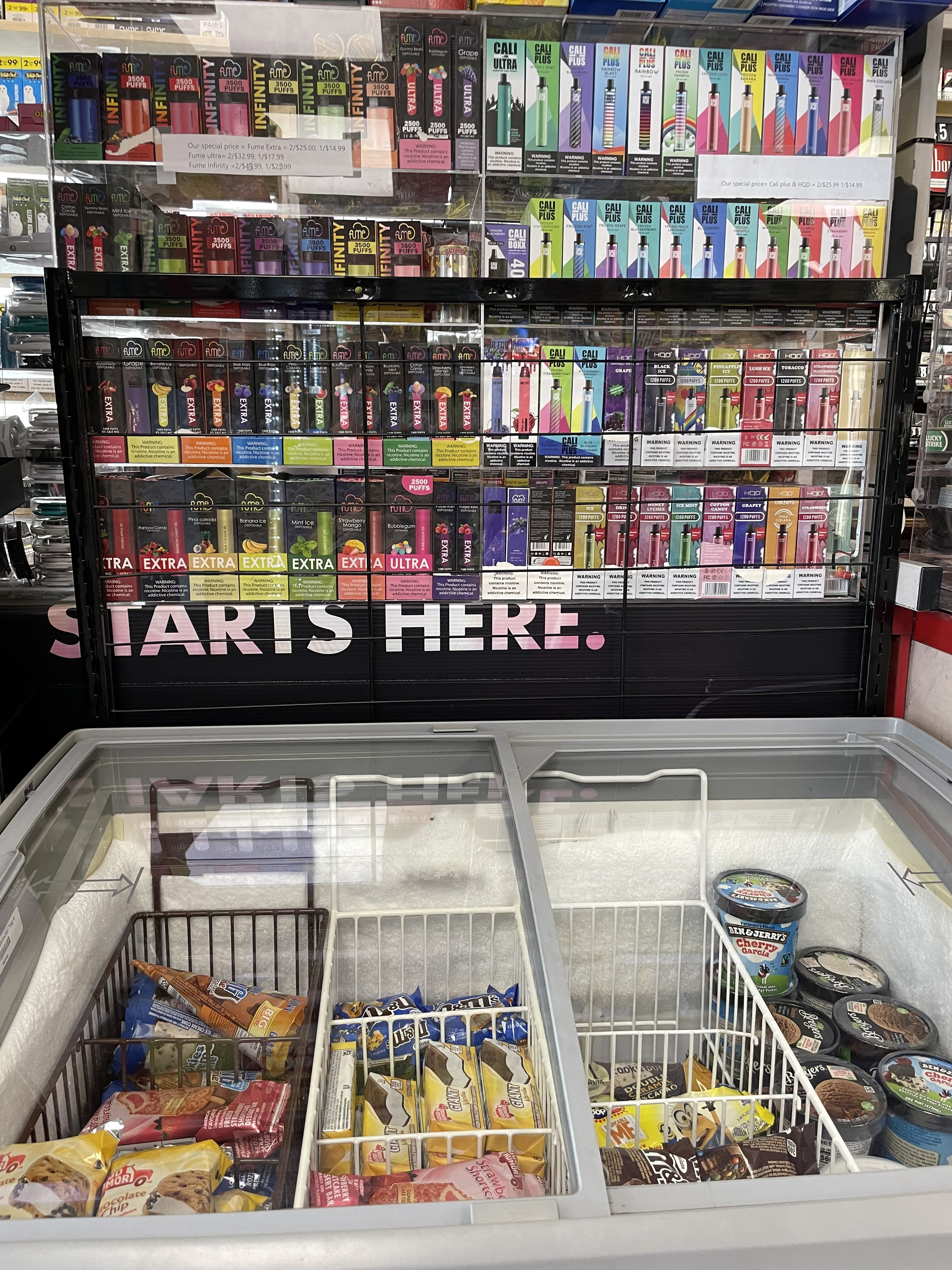 flavored e-cig display above an ice cream cooler 