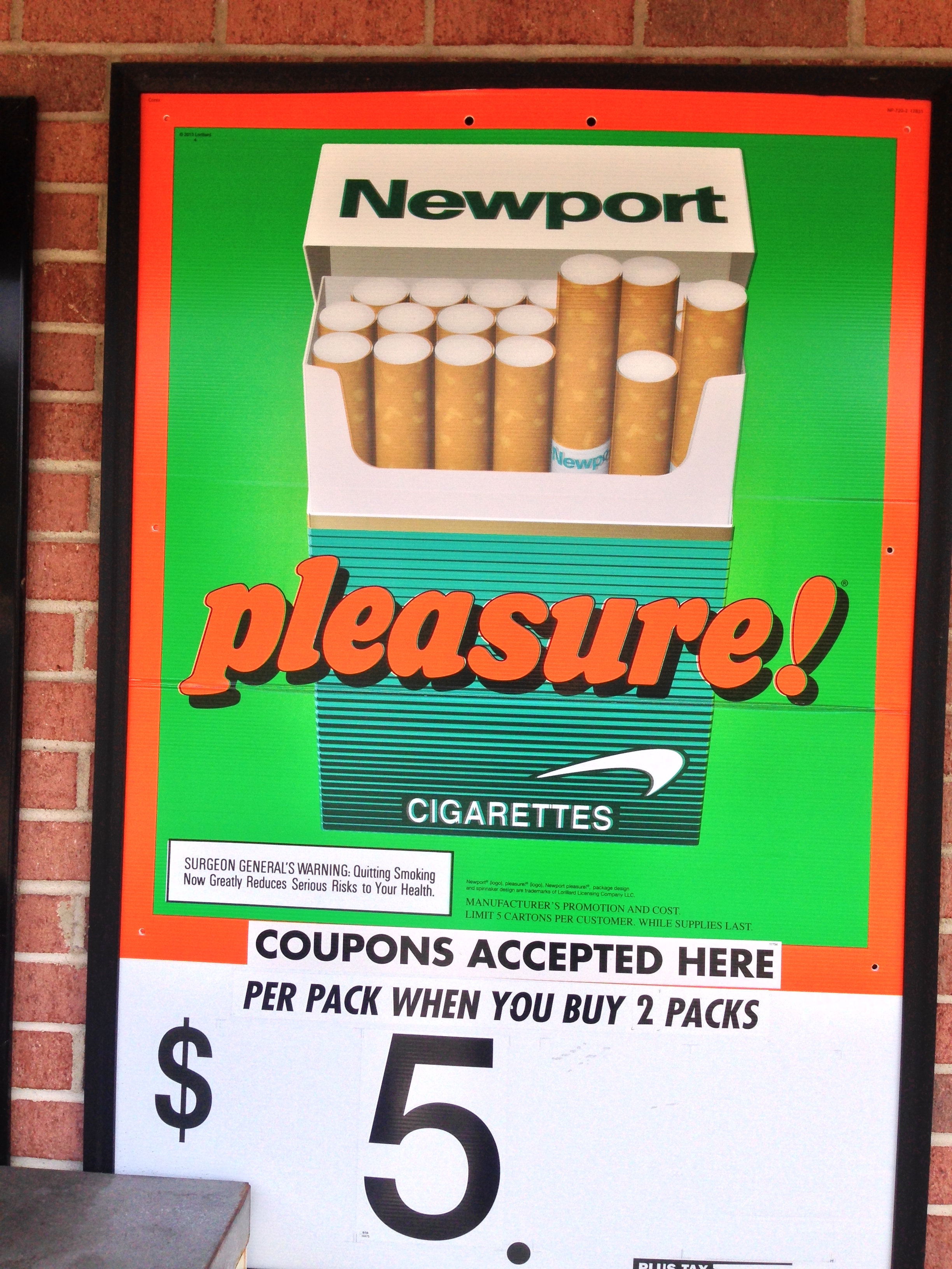 Newport menthol cigarette ad on the exterior of a retailers with "coupons accepted here. $5 per pack when you buy 2 packs"