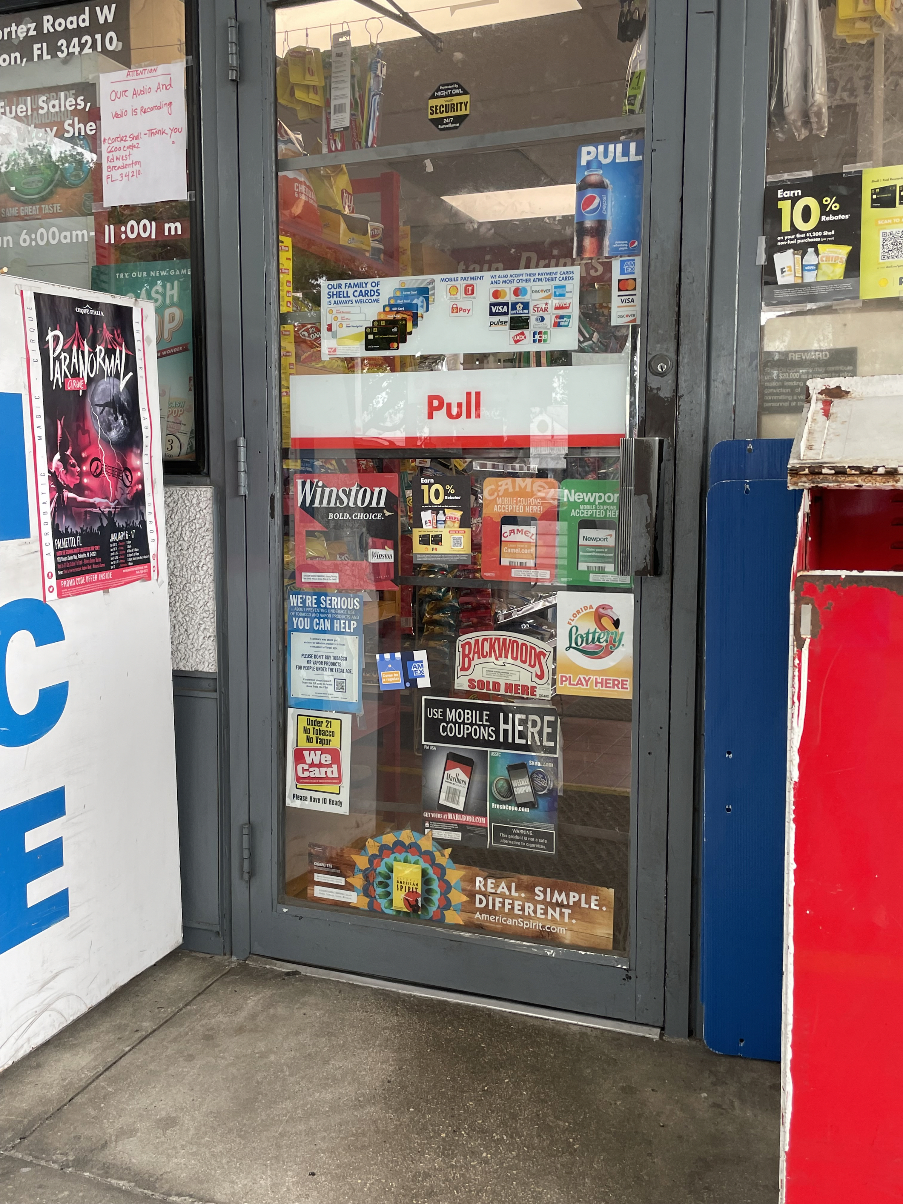 exterior door to a tobacco retailer covered in ads 