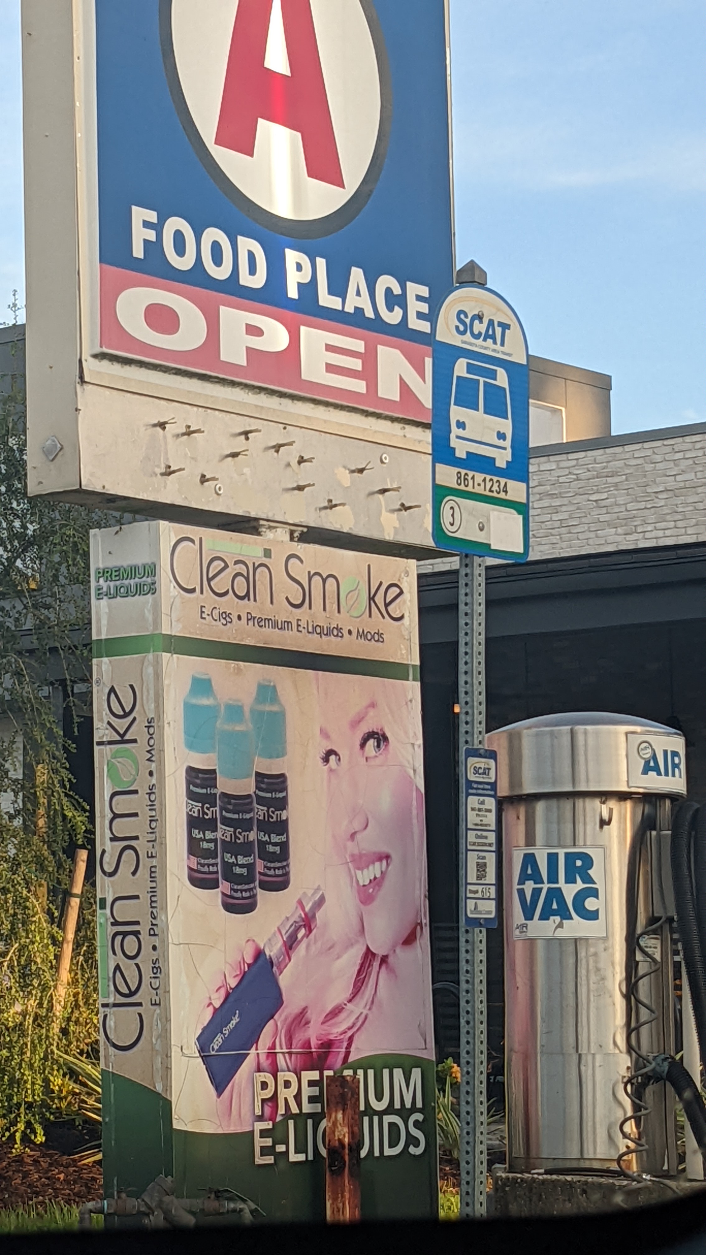 E-cigarette ad beside a bus stop outside a retailer 