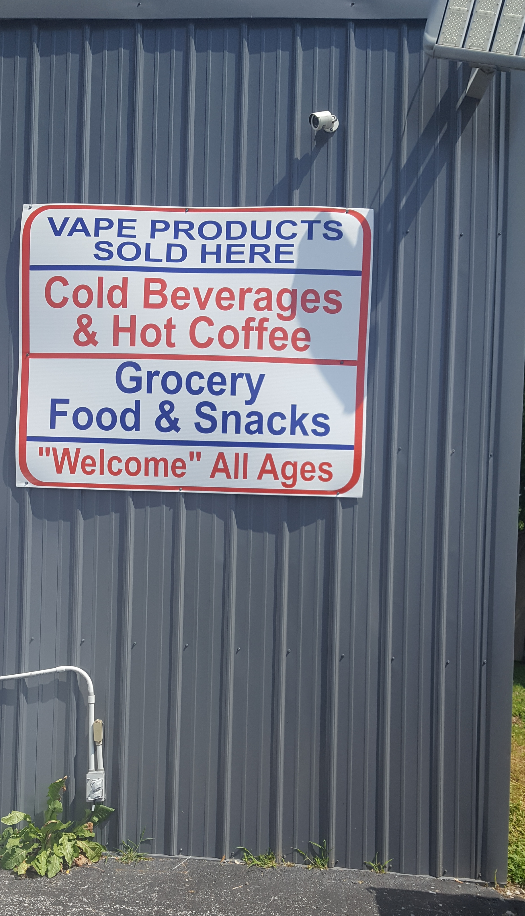 Sign saying "Vape Products Sold Here" and "Welcome All Ages"