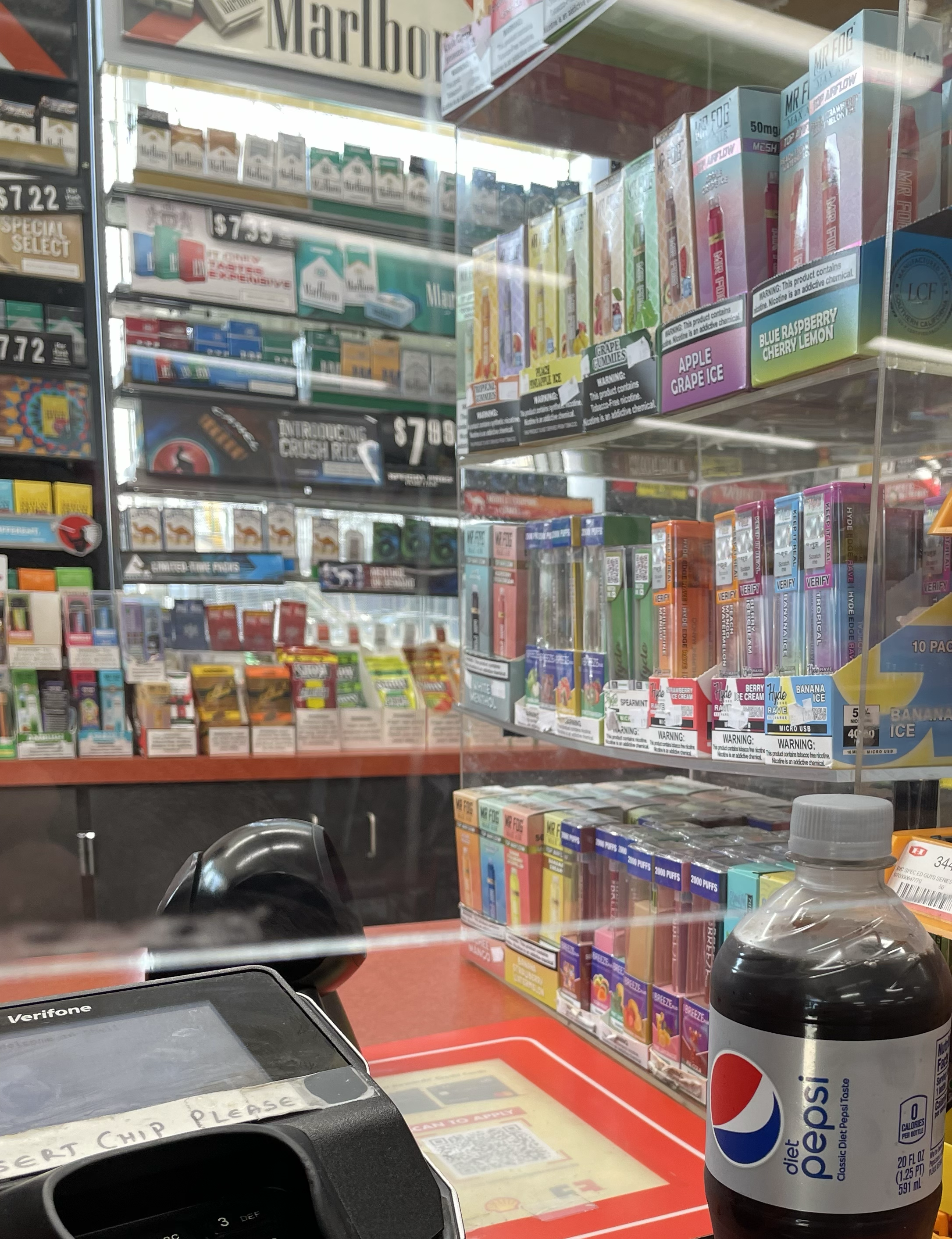flavored e-cig and other tobacco product display behind the counter 