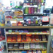 Flavored tobaco case surrounded by candy bars.