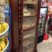 Cigar case hanging open next to soda and gumballs