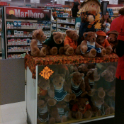 Teddys bears dressed for Fall in front of Marlboro cigarettes