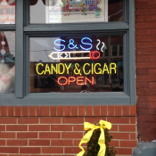 Neon sign at a combined tobacco and candy shop