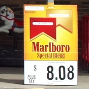 Marlboro price placard in front of child's ride.