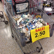 Illegal self-service display of discounted cigarettes next to toys and candy in a supermarket.