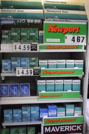 Multiple shelves at retail location of Kool and Newport menthol cigarettes being sold with "special offer"