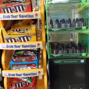 E-cig liquid next to display of M&Ms with ironic "Grab your favorites" label.
