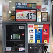 Cigarette and moist snuff advertisements above gas pump