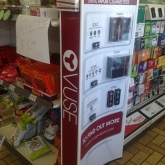 Interior VUSE e-cigarette ad with product display near candy