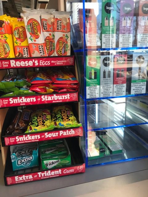 E-cigarette displays on teh counter next to candy