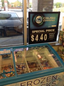 'Special Price' Camel cigarettes sign next to self-serve cooler with ice cream