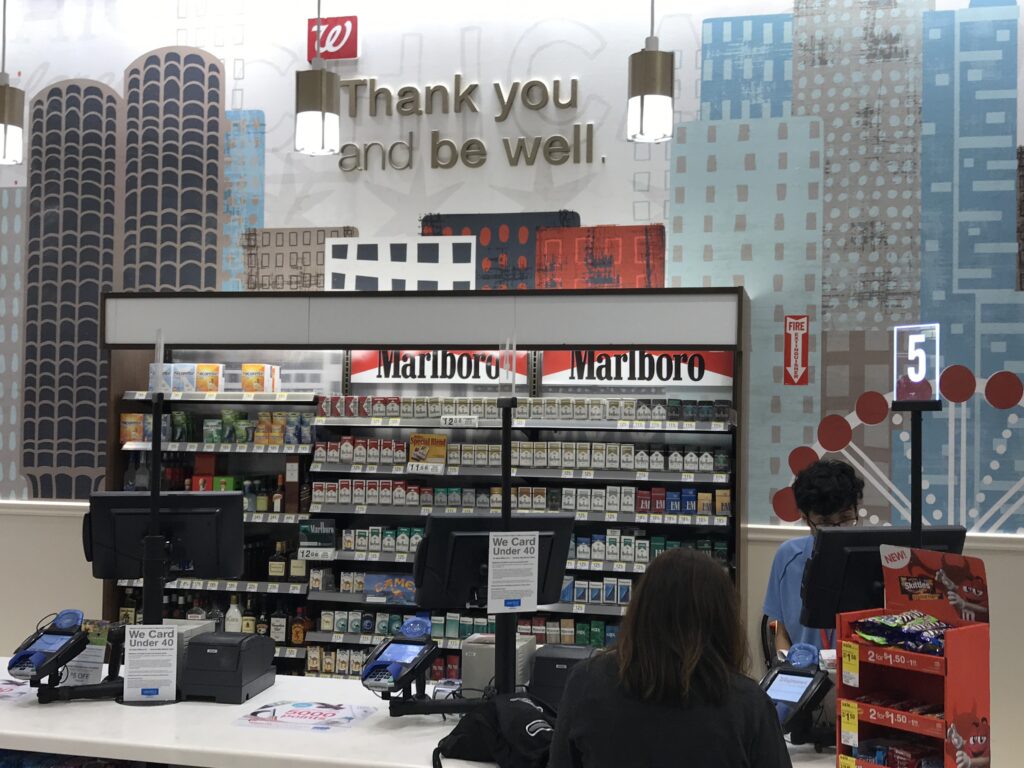 "Thank you and be well" sign above a tobacco display at a Walgreens 